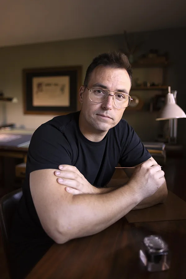 Pink and black open pouch with a lining triangle and a thank you postcard.